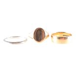 Three gold rings, an 18 carat white gold wedding band, 2.1mm wide, approximate weight 3.