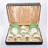 A set of six Bisto china coffee cans and saucers, together with six silver seal top coffee spoons,