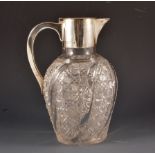 A cut glass silver mounted claret jug, the vase shaped body with wavy mould and hobnail cut,