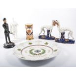 Pair of Staffordshire greyhound pen stands, another pair of Staffordshire figures, armourial dish,