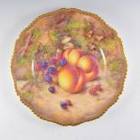 A Royal Worcester plate, wavy rim, painted number C55, painted with fruit by John Freeman, signed,