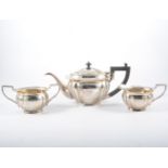 A white metal three-piece teaset, marked SILVER 90S,