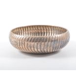 A circular white metal bowl, marked 925, spiral fluted, 8oz, diameter 15cm.