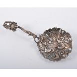 Asian silver ornamental sifter spoon, indistinctly marked, flower-head bowl, with a sprig handle,