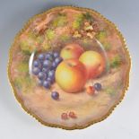 A Royal Worcester plate, wavy rim, painted with fruit by John Freeman, signed, diameter 23.5cm.