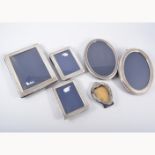 Six silver photograph frames, five modern frames, rectangular and oval with bead,