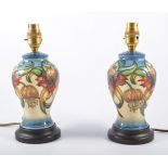 Nicola Slaney for Moorcroft Pottery 'Anna Lily', pair of lamp bases, raised on turned plinths, 24.