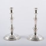 Pair of George I style silver candlesticks, turned nopped column, circular bases, by Comyns, London,