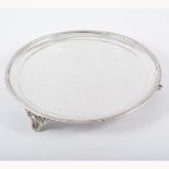 Victorian circular silver salver, London 1883, beaded outline, raised on three cast scroll feet,