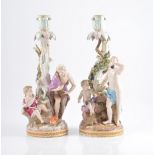 Pair of Meissen candlesticks, scrolled and figural columns, under-glazed blue cross swords mark,