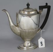 An Edwardian demi-fluted silver oval coffee pot, London, 1907, 9.5in, gross 19 oz.