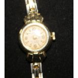 A lady's 14ct gold wrist watch, on a gilt metal bracelet.