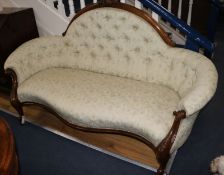 A Victorian carved walnut serpentine button back settee, W.180cm