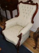 A Victorian style carved walnut armchair and another similar chair