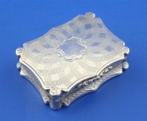 An early Victorian silver vinaigrette by Nathaniel Mills, of shaped rectangular form, with