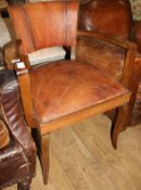 A 1920's French beech and tan leather elbow chair