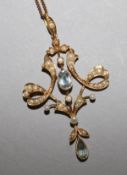 An Edwardian 15ct gold, aquamarine and seed pearl set pendant, on a 9ct gold fine link chain.