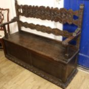 A 19th century French walnut and beech box seat settle, with scroll carved back, W.4ft 5in. D.1ft