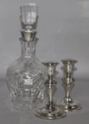 A decanter and a pair of silver candlesticks