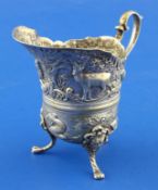 A late 19th century? Italian embossed silver cream jug, decorated with wild animals and sea