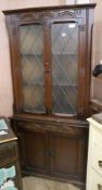 A carved oak standing corner cupboard, H.178cm