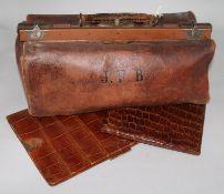 A leather Gladstone bag, an Asprey's crocodile skin stationery wallet with stamp pouch and a folding