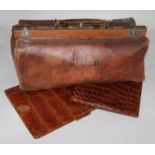 A leather Gladstone bag, an Asprey's crocodile skin stationery wallet with stamp pouch and a folding