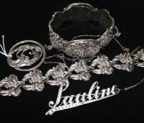 A silver bracelet, pendant and brooch and a white metal hinged bangle.