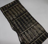 A gold and black 1030's Egyptian metallic stole