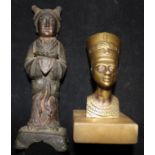 A figure of Kwan Yin and an Egyptian head paperweight