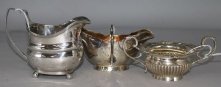 A George III silver cream jug, a silver and gilt two-handled sauce boat and a small silver two-