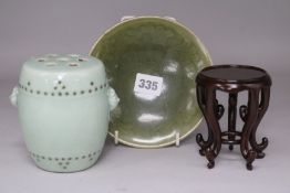 A Chinese celadon dish and a celadon glazed barrel, wood stand