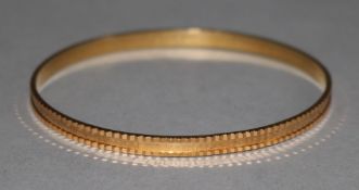 An Arabic gold bangle.