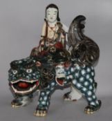 A Chinese ceramic temple dog with figure