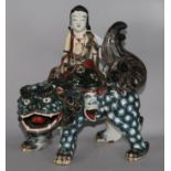 A Chinese ceramic temple dog with figure