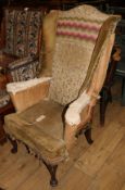 A 1930's mahogany wing armchair