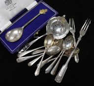 A Silver tea strainer, 10 silver teaspoons, a cased commemorative spoon, pickle fork, cake form, and