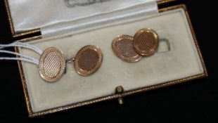 A cased pair of engine turned 9ct gold cufflinks.