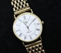 A gentleman's 9ct gold Longines quartz wrist watch on an associated 9ct gold bracelet.