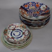 Five Imari chargers with scalloped edges, two similar plates, three Canton plates and a famille rose