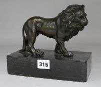 A 19th century bronze standing lion on black marble base