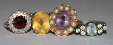 Three 9ct gold and gem set rings and a white metal ring.