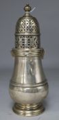 A silver lighthouse sugar sifter