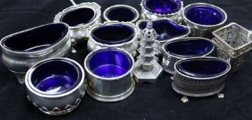 Pair of Chinese pierced silver salts and a 'pagoda' pepper, nine silver salts with blue glass liners
