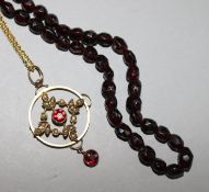 A garnet bead necklace and a gem set pendant.
