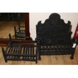 Two wrought iron fire grates and a fire back, grates W.60cm and 4cm, fire back W.60cm