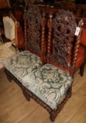 A pair of 19th century Flemish style carved walnut dining chairs