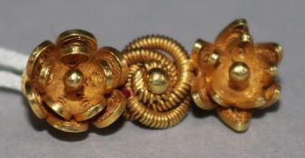 A yellow metal brooch.