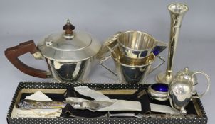 An Art Deco silver three piece tea set, a silver cruet stand, a carving set and a vase
