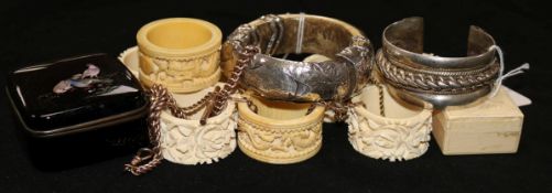 A set of six foliate-carved ivory napkin rings, pair of dragon-carved examples, two white metal
